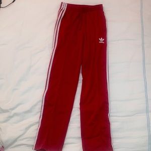 Red adidas track pants
